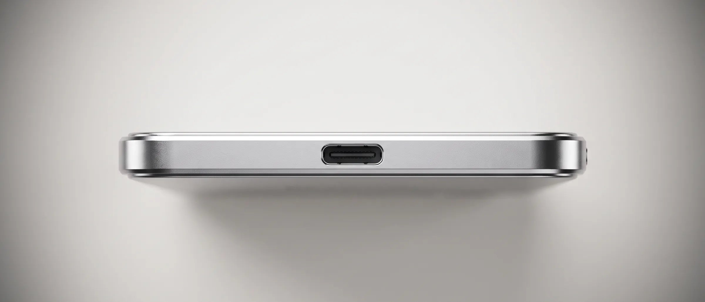 Close-up of HELION AIR’s bottom edge: brushed aluminium, a polished chamfer and the USB-C port